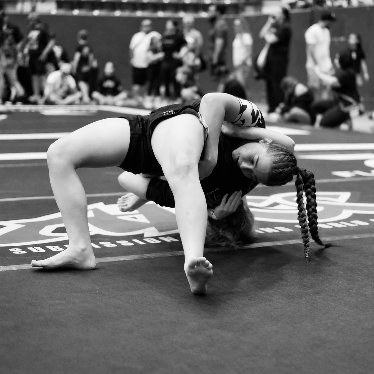 Two teenage girls grappling on the mat at the ADCC Austin Open