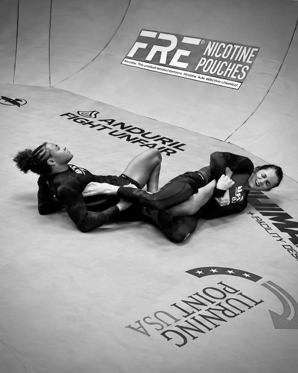 Two grapplers in a leg-lock exchange on the mat