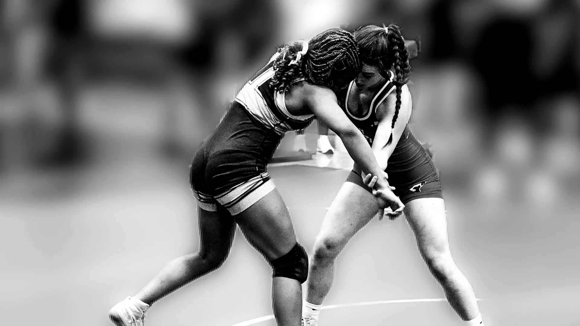 Two girls locked in a tie-up during a freestyle wrestling match